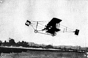 Early 1900s airplane over a field