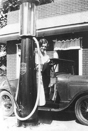 Helen Boltz filling up a flivver at the hand-pump.