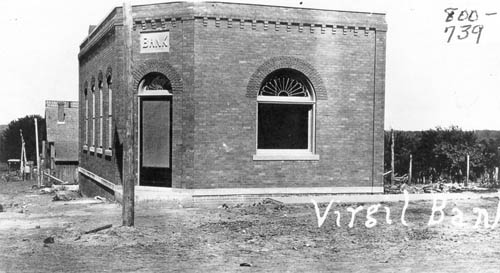 The Virgil Bank, a small stone builiding on the corner of unpaved streets