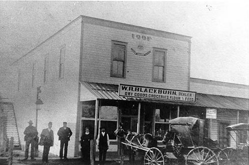 Blackburn Dry Goods and Groceries:  view from the busy street (buggy in front)