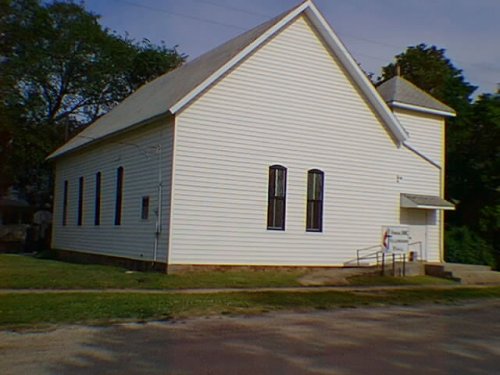 A white ckapboard building, with the clean lines of a simple church