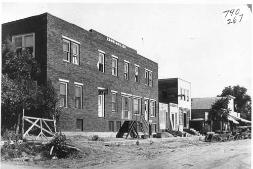 Two-story brick building (no porches as in the present-day photograph), on an unpaved street.