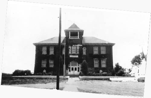 Imposing, large building, with a bell tower front and center.
