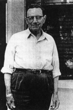 Photograph of James C. Malin, smiling and in shirt-sleeves; high forehead, black-rimmed glasses and a strong but warm face