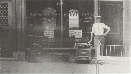 storefront, proprietor standing on the sidewalk